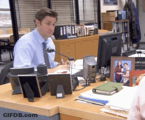A Man Sits At A Desk In Front Of A Hp Computer Monitor GIF