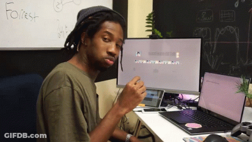A Man Sits At A Desk In Front Of A White Board That Has The Word Forest Written On It GIF
