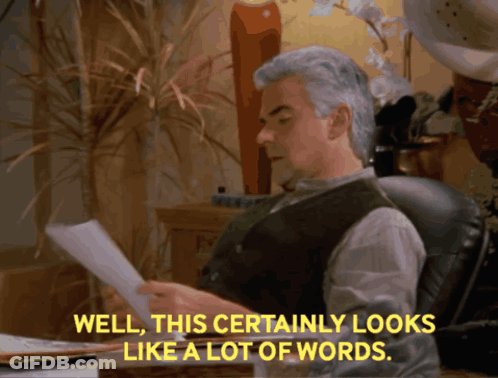 A Man Sits At A Desk Reading A Piece Of Paper With The Words Well This Certainly Looks Like A Lot Of Words GIF