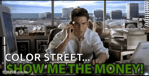 A Man Sits At A Desk Talking On A Cell Phone With The Words Color Street Show Me The Money Below Him GIF