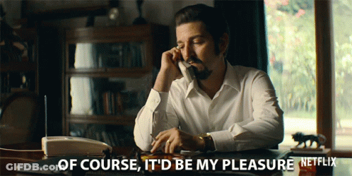 A Man Sits At A Desk Talking On A Phone With The Words Of Course It 'D Be My Pleasure GIF