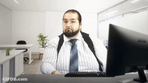 A Man Sits At A Desk With A Benq Monitor GIF
