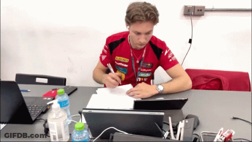 A Man Sits At A Desk With A Laptop And A Bottle Of Coca Cola In Front Of Him GIF