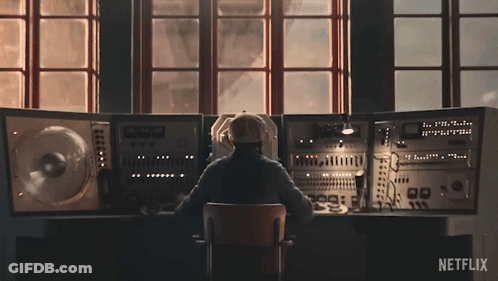Man Sitting At Desk With Netflix Logo GIF