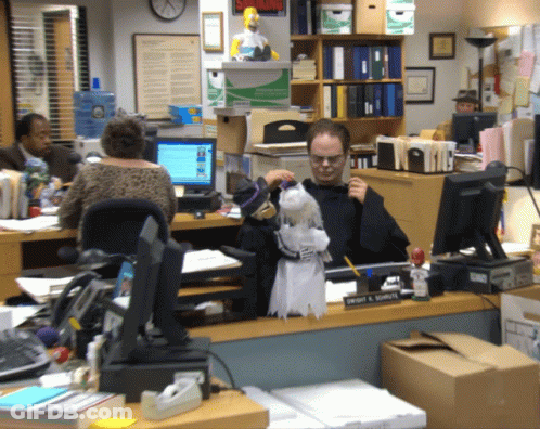 A Man Sits At A Desk With A Sign That Says Smoking On It GIF