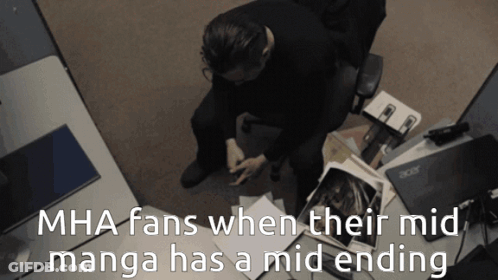 A Man Sits At A Desk With Acer Laptops And Papers GIF