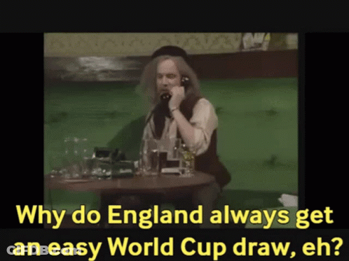 A Man Sits At A Table Talking On A Phone With The Words Why Do England Always Get An Easy World Cup Draw Eh GIF