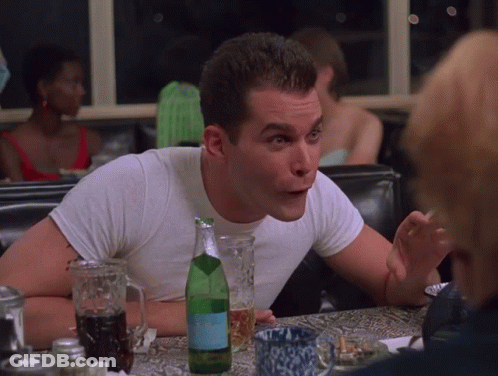 A Man Sits At A Table With A Bottle Of Aquafina GIF