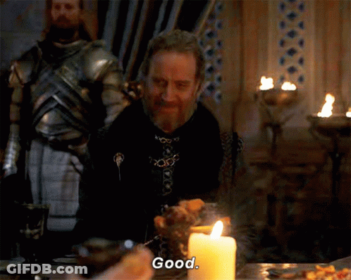 A Man Sits At A Table With A Candle And Says " Good " GIF