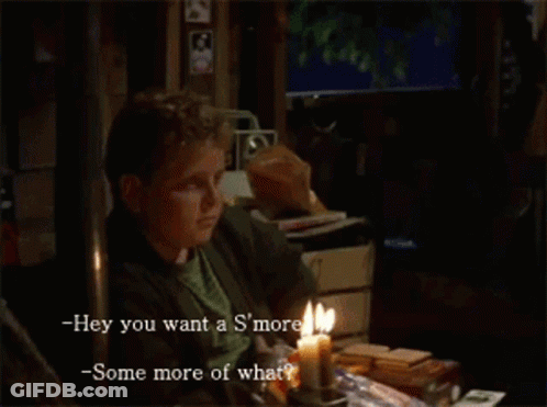 A Man Sits At A Table With A Lit Candle And Says Hey You Want A S'more -Some More Of What GIF