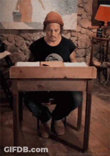 A Man Sits At A Wooden Desk With The Words " The Social Darkness Tumblr " On The Bottom Right GIF