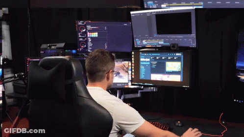 A Man Sits In A Chair In Front Of A Computer Monitor That Says ' A ' On It GIF