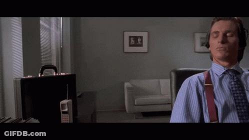 A Man Sits In A Chair With His Eyes Closed In A Living Room GIF