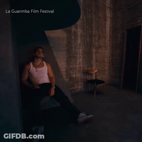 A Man Sits In A Dark Room With La Guarimba Film Festival Written On The Top GIF