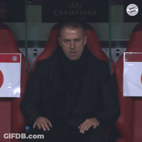 A Man Sits In A Soccer Locker Room With A Sign That Says Champions GIF
