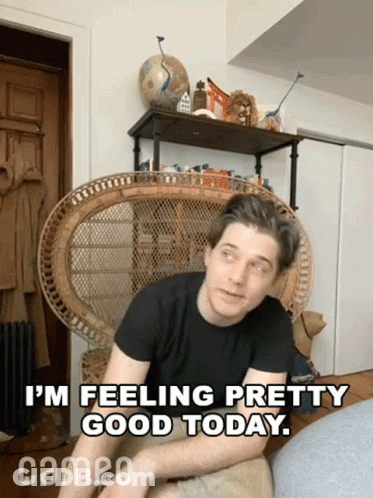 A Man Sits In A Wicker Chair With The Words " I 'M Feeling Pretty Good Today " Above Him GIF