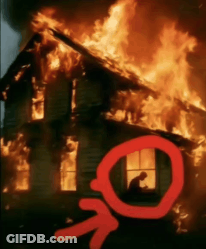 A Man Sits In A Window Of A Burning House With An Arrow Pointing To It GIF