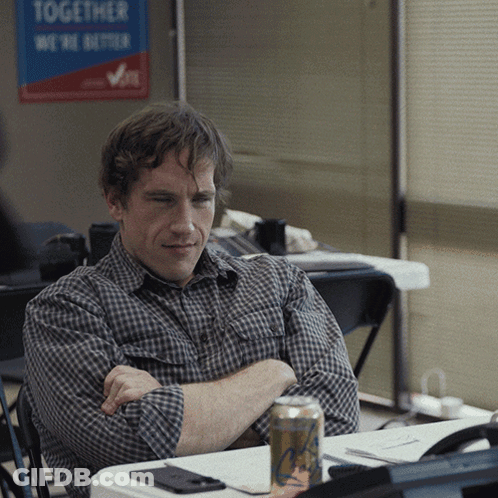 A Man Sits In Front Of A Sign That Says Together We Are Better GIF