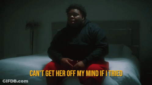 A Man Sits On A Bed With The Words " Can 'T Get Her Off My Mind If I Tried " Above Him GIF