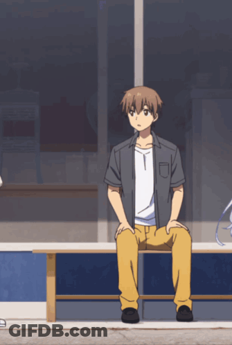 A Man Sits On A Bench With His Legs Crossed GIF
