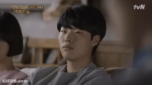 A Man Sits On A Couch With A Tvn Logo In The Corner GIF