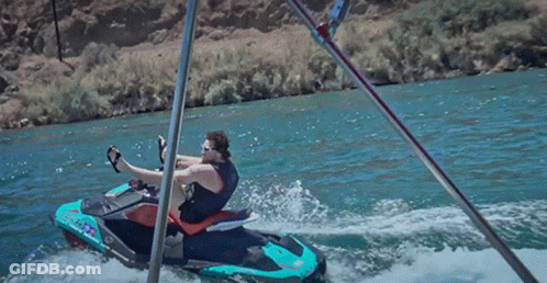 A Man Sits On A Jet Ski That Says ' Jet Ski ' On The Side GIF