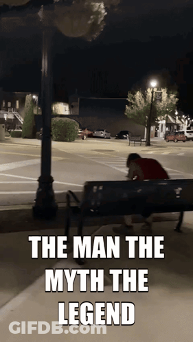 A Man Sits On A Park Bench With The Words The Man The Myth The Legend GIF