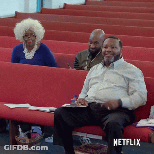 Man Sitting On Church Bench With Netflix Logo GIF