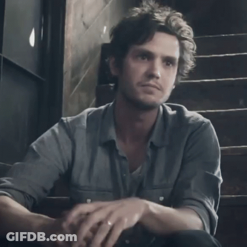 A Man Sits On A Set Of Stairs With The Word Sissy Written On The Front Of His Shirt GIF