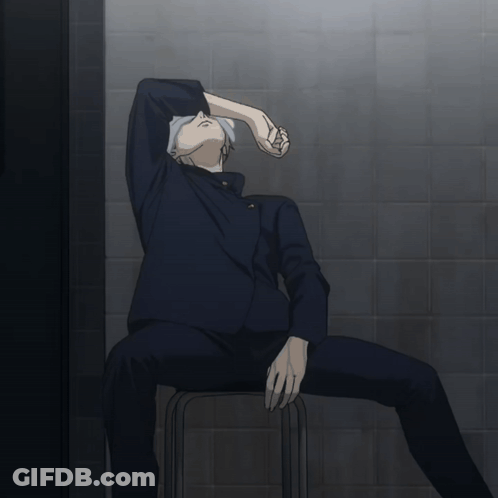 A Man Sits On A Stool With His Head Down GIF