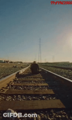 A Man Sits On A Train Track With The Year 2005 On The Bottom Right GIF