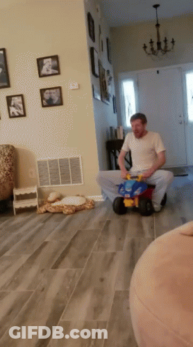 Man Playing With Toy Car On Floor GIF