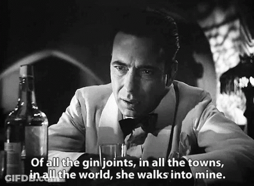 A Man Sitting At A Bar With A Bottle Of Gin And A Glass Of Gin .. GIF
