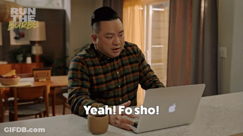 A Man Sitting At A Counter Using An Apple Laptop And Says Yeah Fo Sho GIF