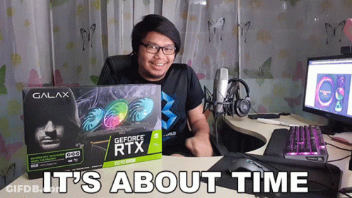 A Man Sitting At A Desk Holding A Box Of A Geforce Rtx Card GIF