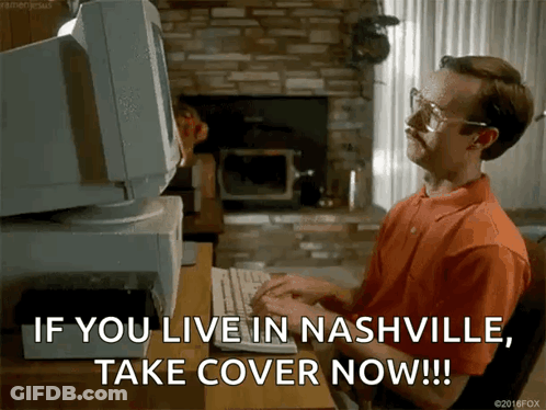 A Man Sitting At A Desk Typing On A Keyboard With The Words If You Live In Nashville Take Cover Now GIF