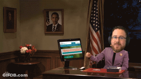 A Man Sitting At A Desk With A Computer Screen That Says Virus Download On It GIF
