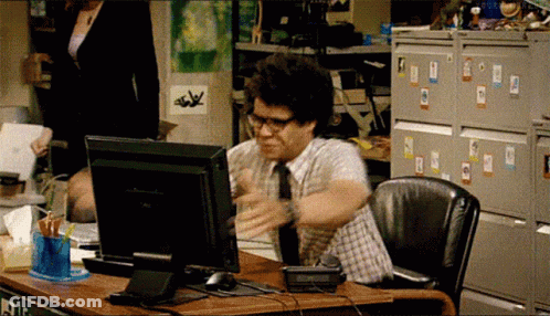 A Man Sitting At A Desk With A Dell Computer On It GIF