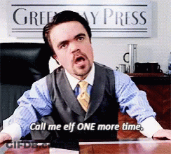 A Man Sitting At A Desk With A Sign That Says Greenway Press GIF