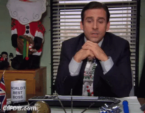 A Man Sitting At A Desk With A World 'S Best Boss Mug On It GIF