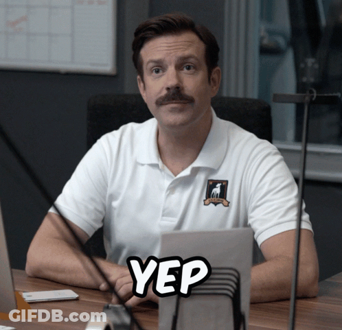 A Man Sitting At A Desk With A Yep Sticker GIF