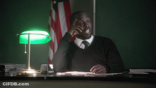 A Man Sitting At A Desk With The Words " Can I Object " Behind Him GIF