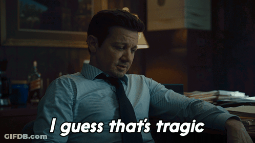 A Man Sitting At A Desk With The Words " I Guess That 'S Tragic " Above Him GIF