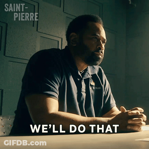 A Man Sitting At A Desk With The Words We 'Ll Do That Written On The Bottom GIF