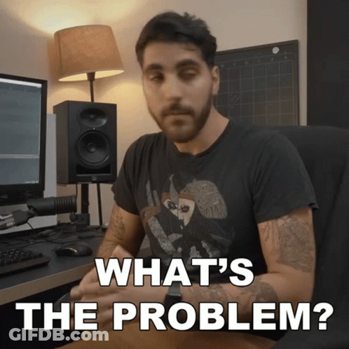 A Man Sitting At A Desk With The Words " What 'S The Problem " Written Above Him GIF