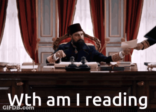 A Man Sitting At A Desk With The Words With Am I Reading GIF