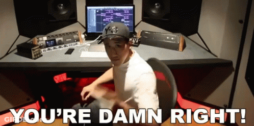 A Man Sitting At A Desk With The Words " You 'Re Damn Right " Written Below Him GIF