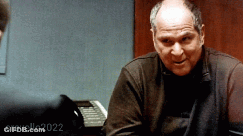 A Man Sitting At A Desk With The Year 2022 Written On The Bottom GIF