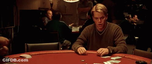 A Man Sitting At A Poker Table With Cards And Chips GIF