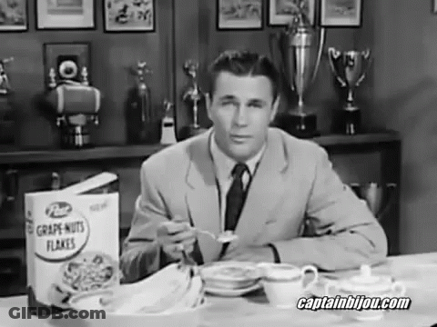 A Man Sitting At A Table Eating Grape Nuts Flakes Cereal GIF